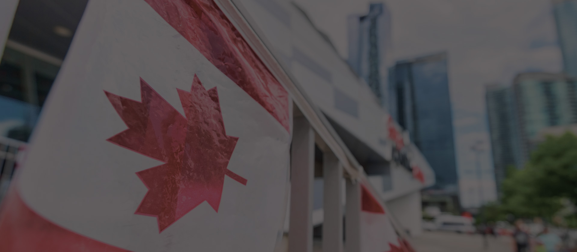 canada plastic flag with blurred urban background in Toronto