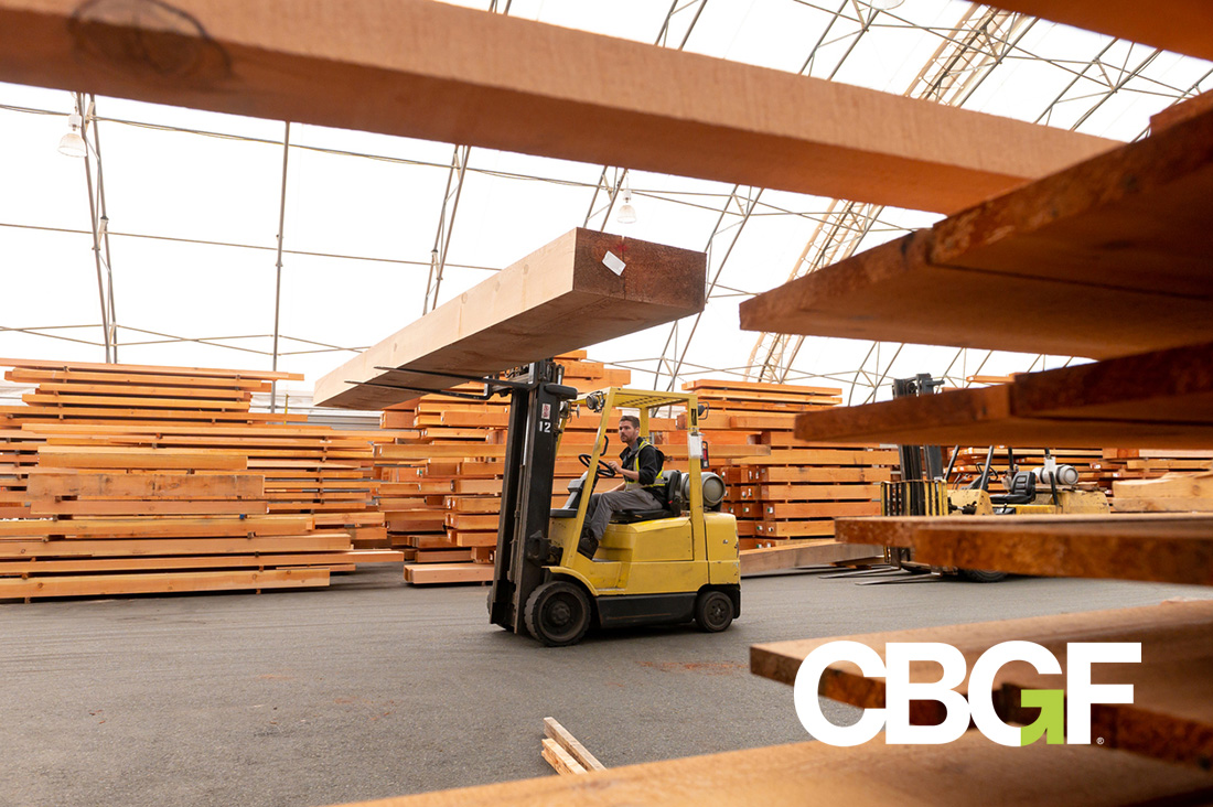 forklift transporting lumber in a lumber manufacturing plant